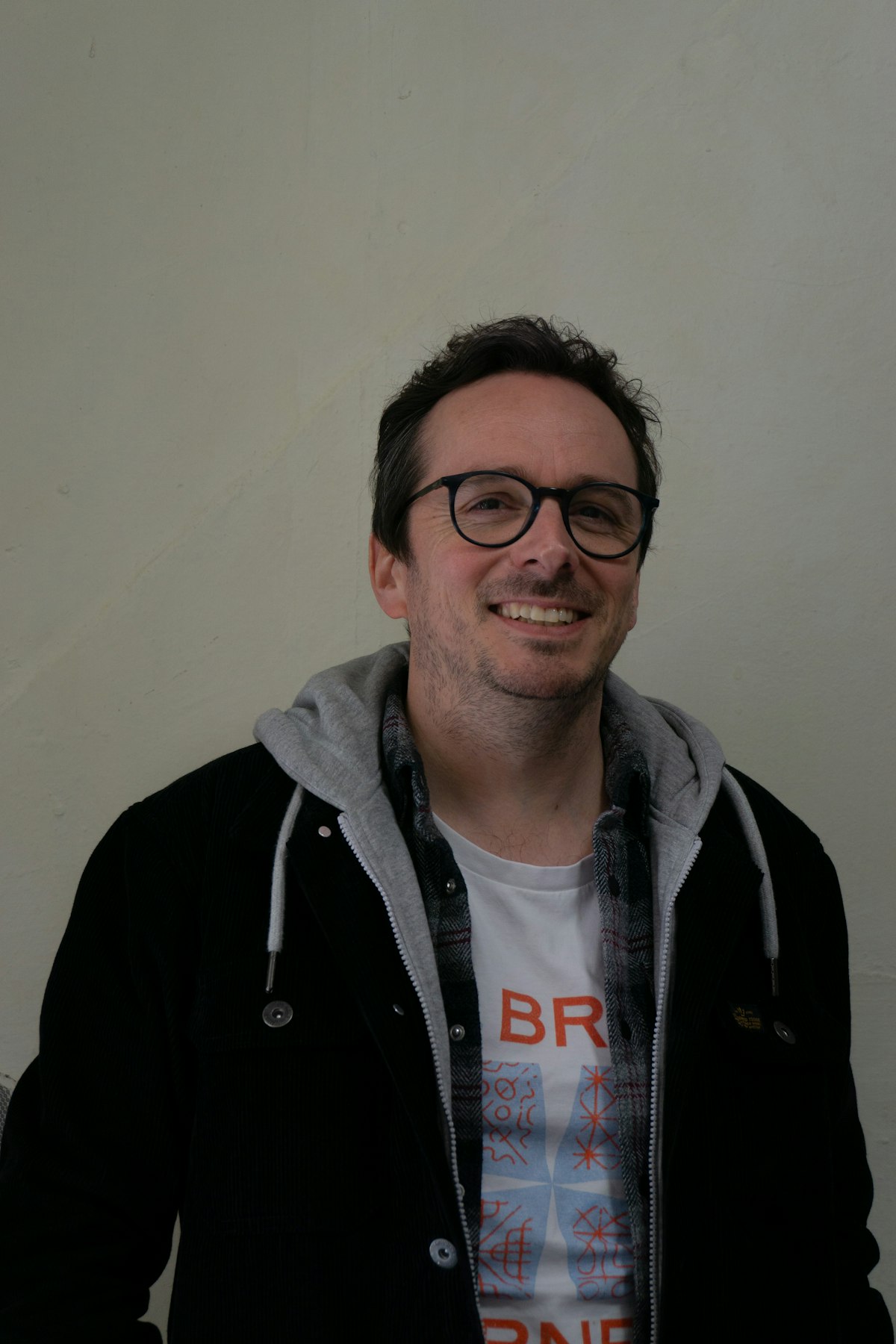 Joe Bailey, standing in front of a plain white background, smiling at the camera.